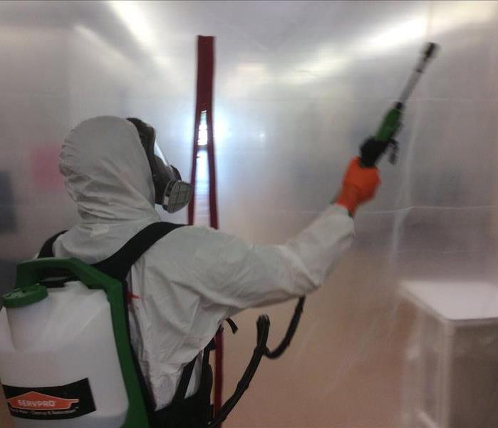 Man in PPE Cleaning a building in Cantonment, Florida