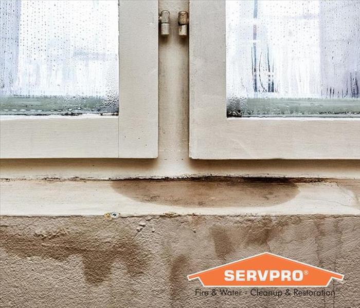 Water leak from a window with SERVPRO logo