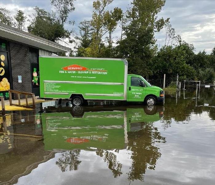 SERVPRO truck in front of a flooded commercial building
